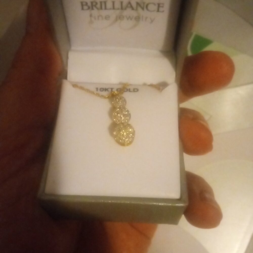 A 3 stone drop down diamond necklace